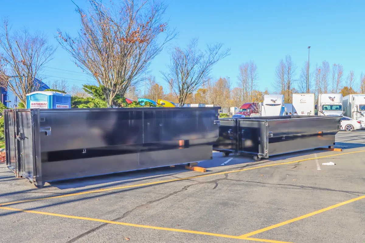 Professional dumpster rental service with roll-off container on residential driveway in Hollister